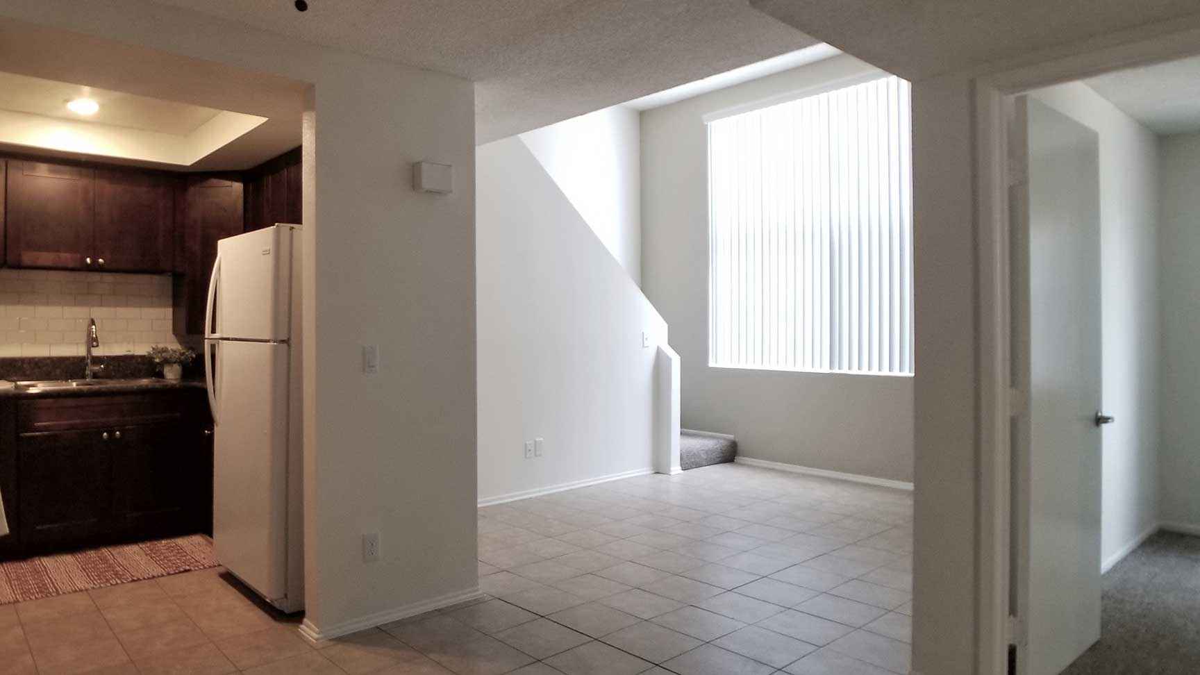 Broadway Apartments open concept living area with tile flooring