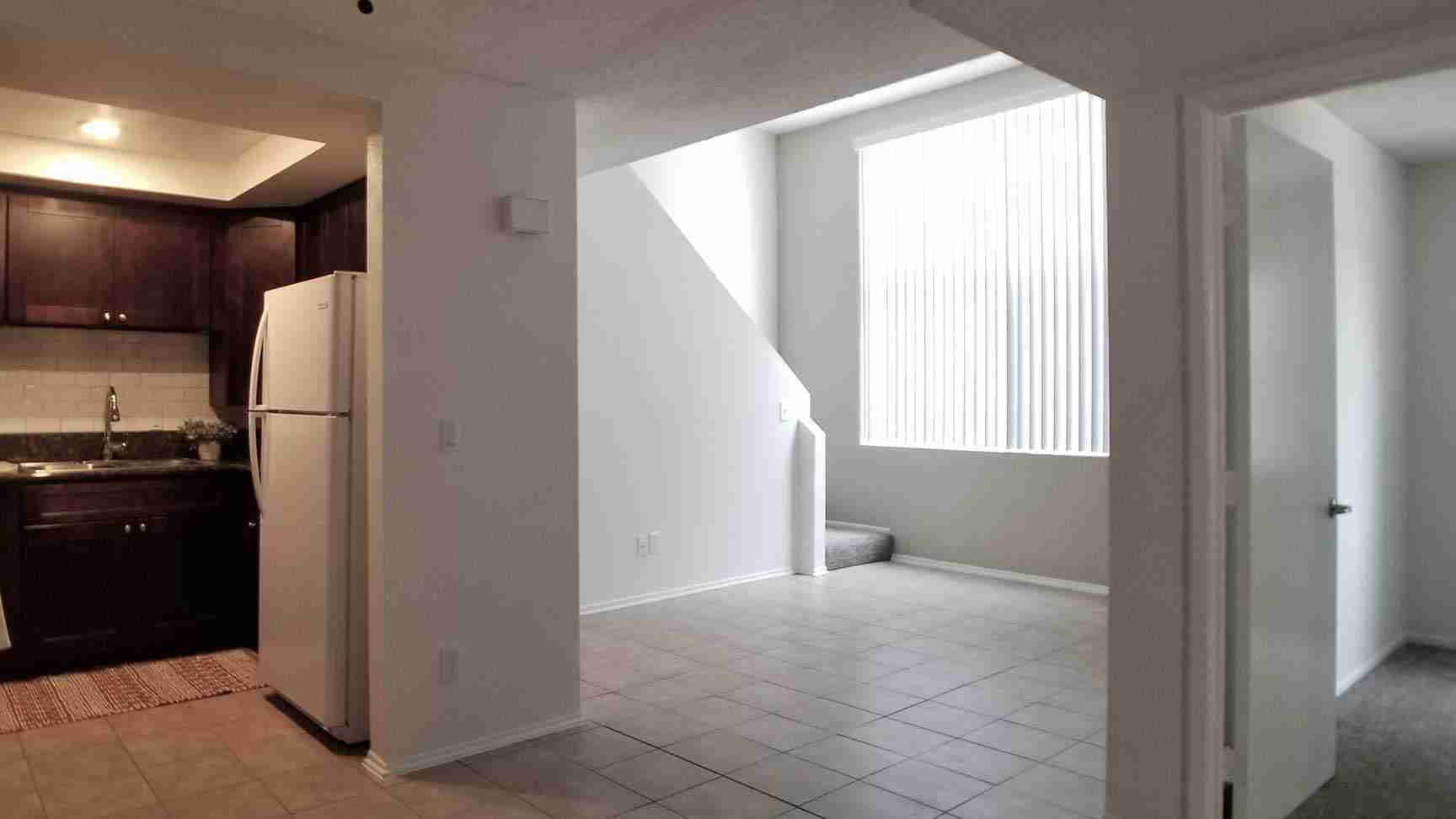Broadway Apartments open concept living area with tile flooring