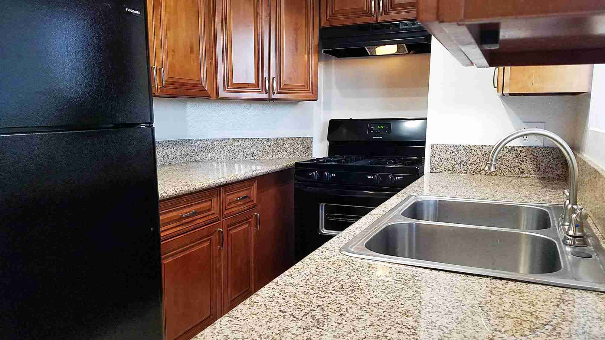 Broadway Apartments renovated kitchen with granite countertops