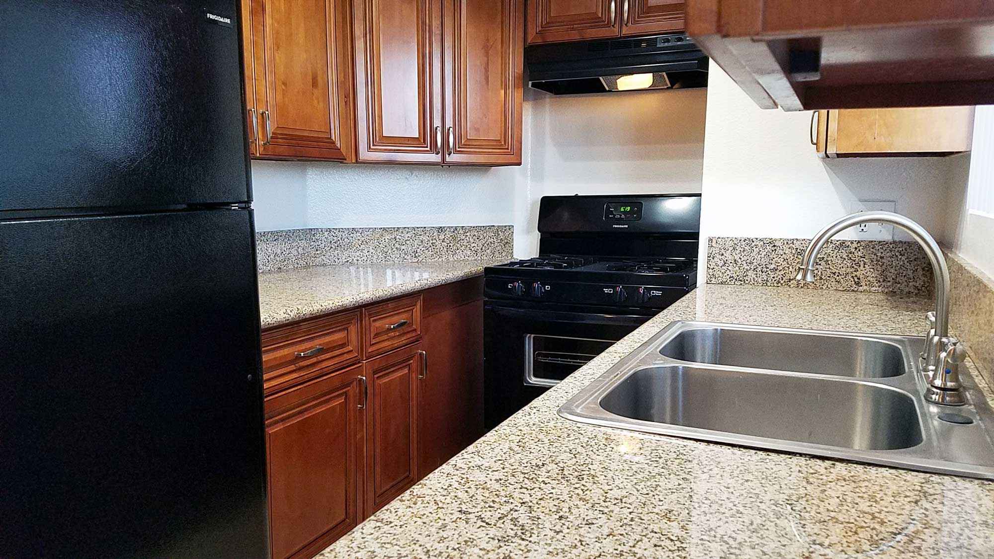 Broadway Apartments renovated kitchen with granite countertops